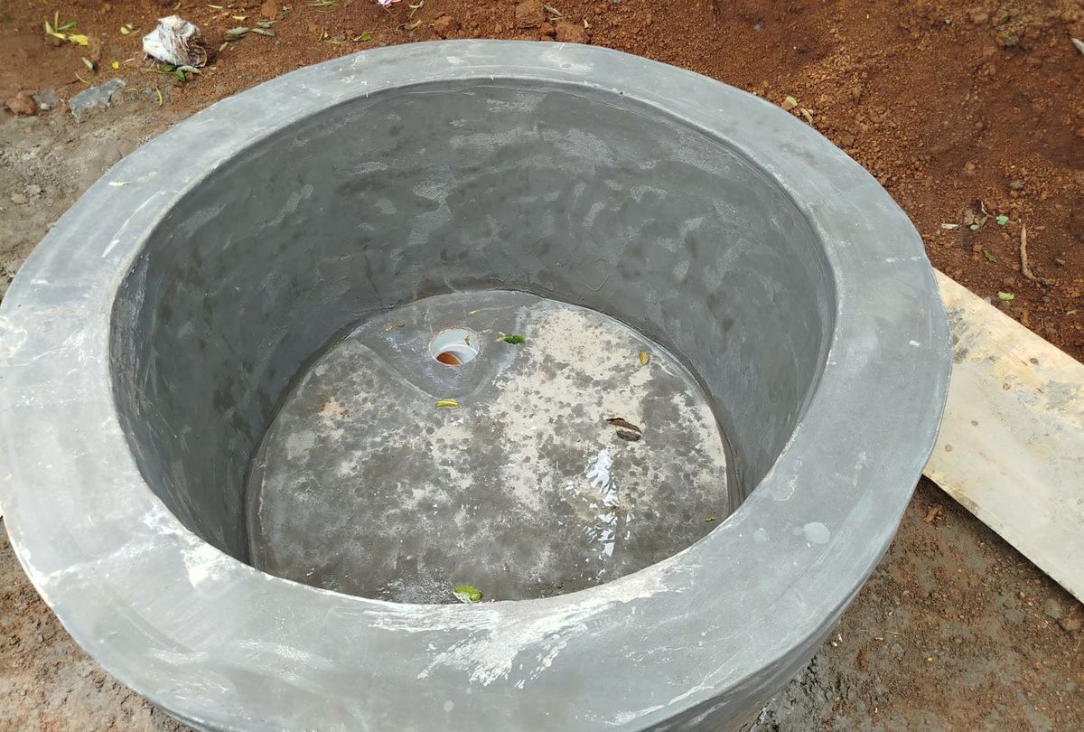 A concrete biogas digester ring under construction